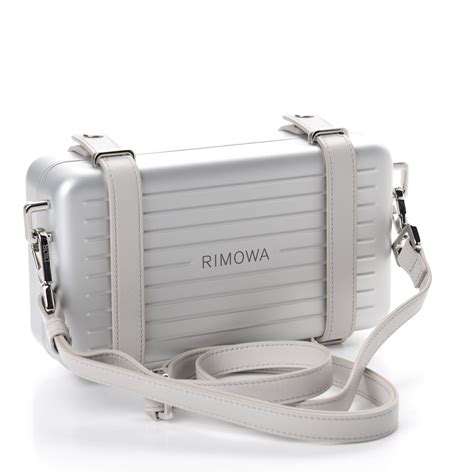 dior silver clutch on strap.